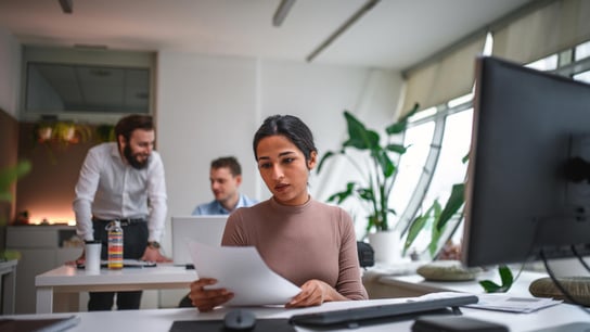 一名20多岁的印度女性在公司办公室里检查文件