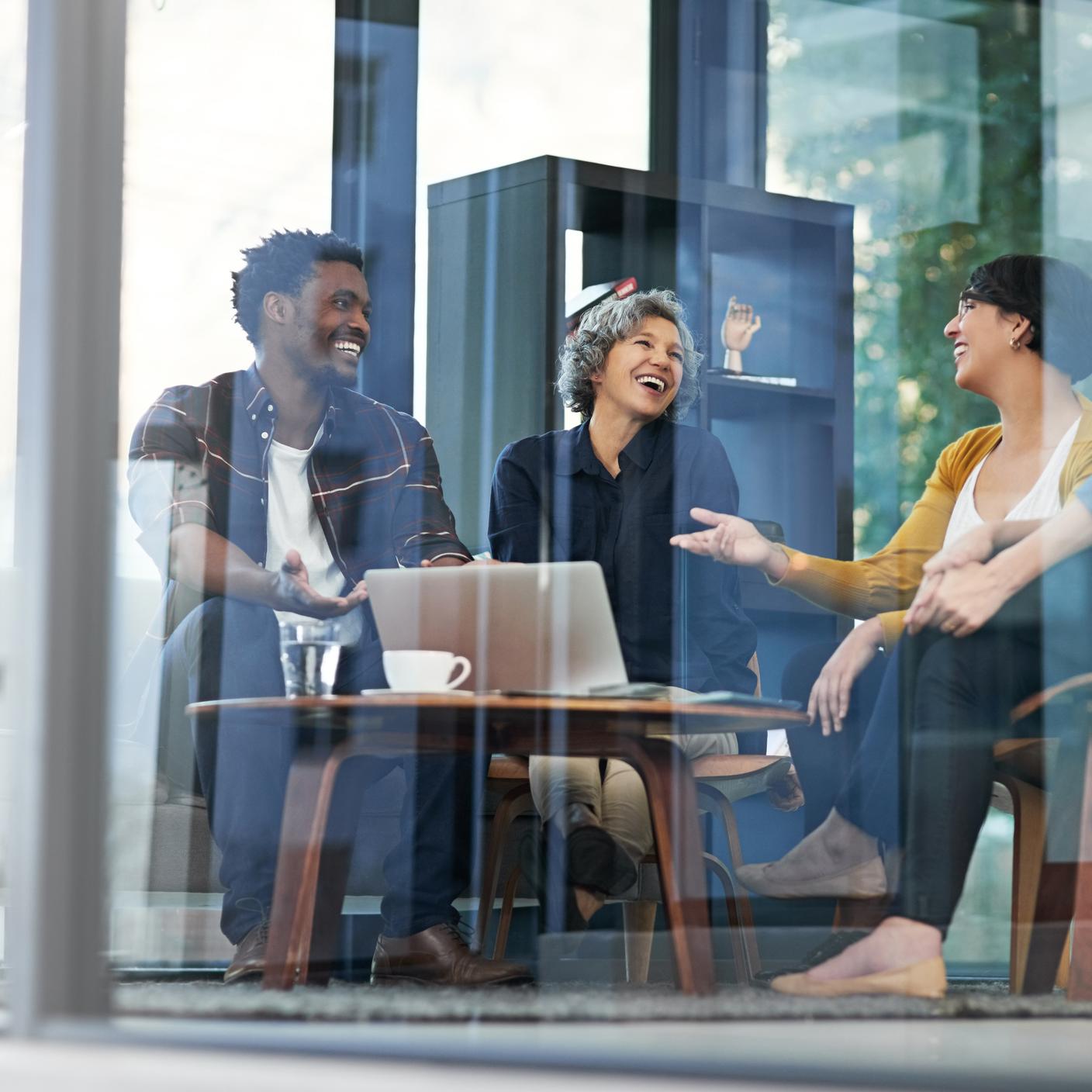 三位面带笑容的人正在开内部管理会议